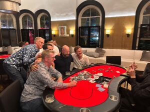 Casino night hire in Auckland with team enjoying poker table entertainment