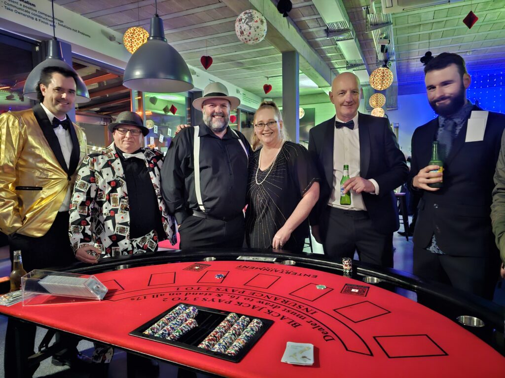Guests enjoying a blackjack table at a corporate casino night hire event