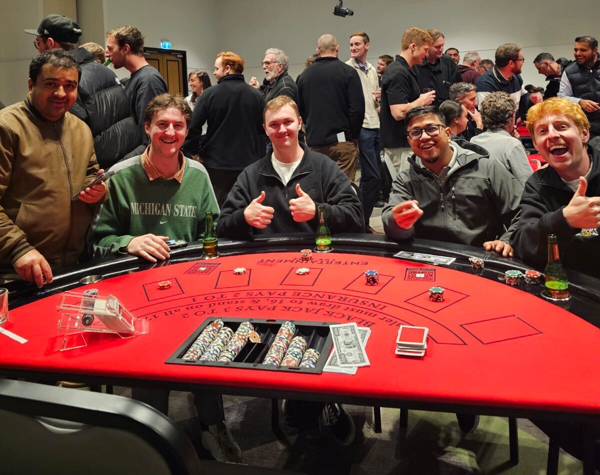 Guests enjoying casino night hire in Auckland at a blackjack table.